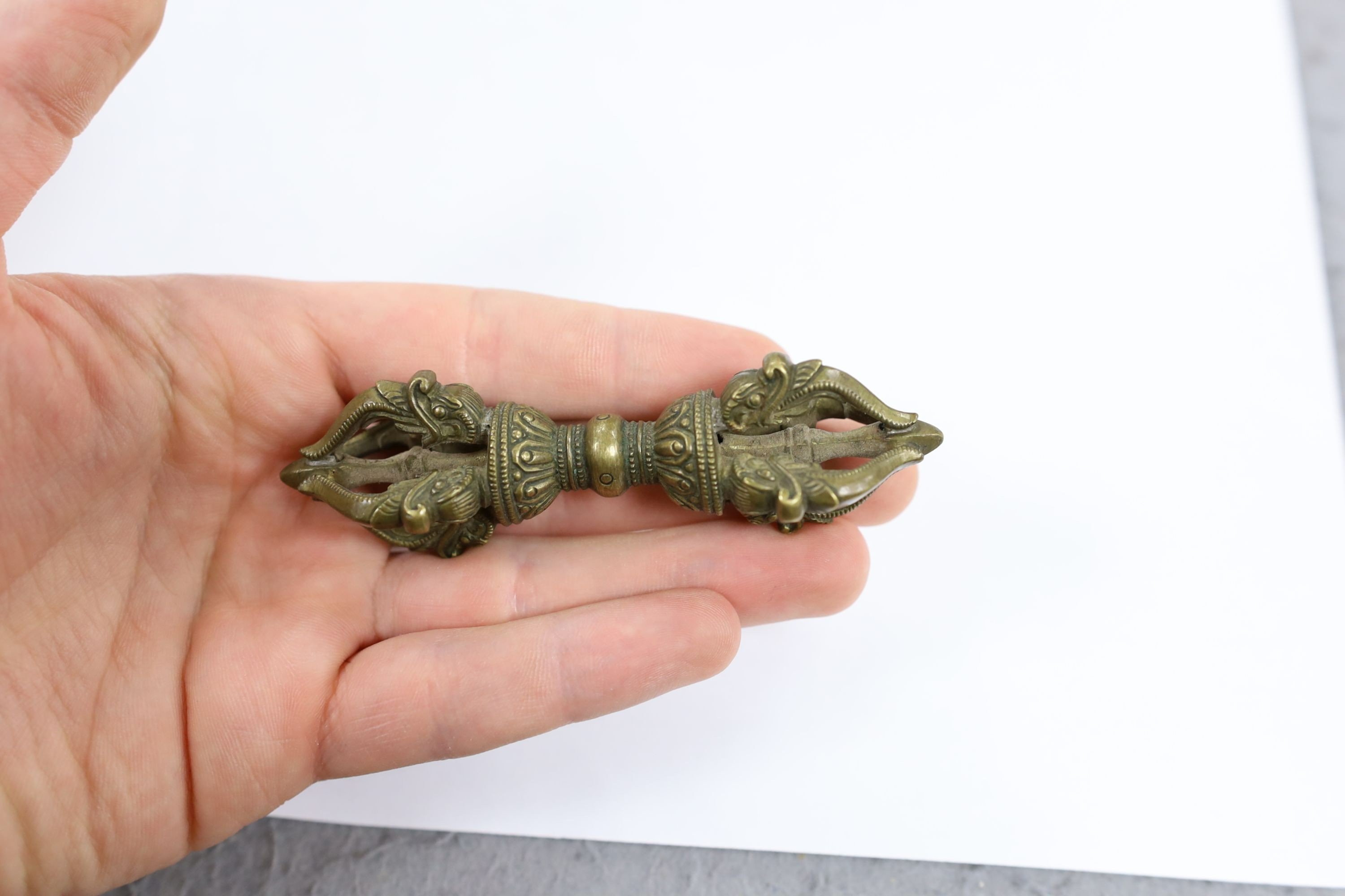 Five Chinese or Tibetan bronze figures or Buddhist implements, tallest 13cms high